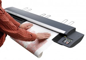 Wide format photo printer feeding paper